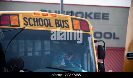 Canton, GA, USA. 7th Aug, 2020. Cherokee High School buses leave school with students at end of first week of in-person fall classes during pandemic worries. The school system mandate masks for all faculty and staff, but declined to insist students wear them. Administrators admitted the county is under a Ã”national microscopeÃ as it reopened face-to-face classes as Covid-19 cases surged in Georgia. Credit: Robin Rayne/ZUMA Wire/Alamy Live News Stock Photo