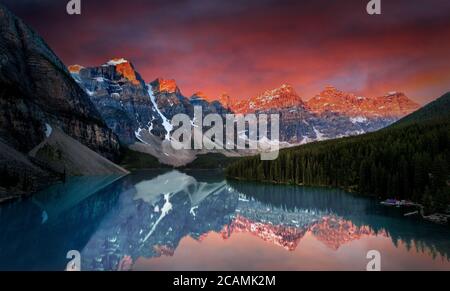 First light of dawn at Moraine Lake with golden sunrise over the Valley of the Ten Peaks in the Canadian Rockies of Banff National Park. Stock Photo