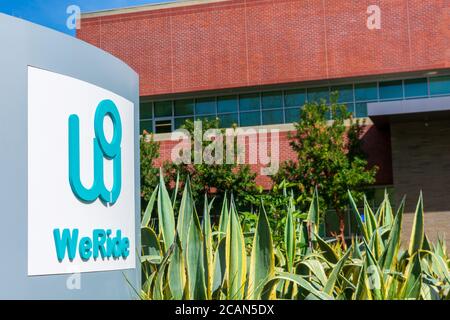 WeRide logo and sign on Silicon Valley office of chinese mobility company. WeRide.ai, formerly Jingchi.ai, works on L4 autonomous driving technologies Stock Photo