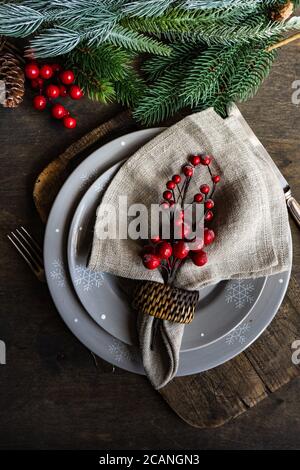 Christmas table setting with holiday decor on rustic table with copy space Stock Photo