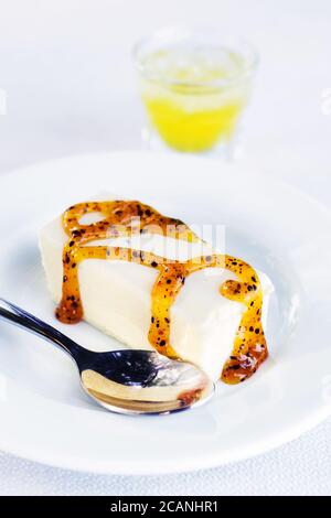 Greek yogurt panna cotta with fruit syrup and lemon liquor (selective focus) Stock Photo