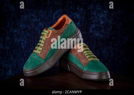 Men's classic green suede shoes on blue background Stock Photo