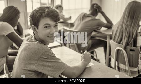 Multi ethnic teenager classroom at school making test. Stock Photo
