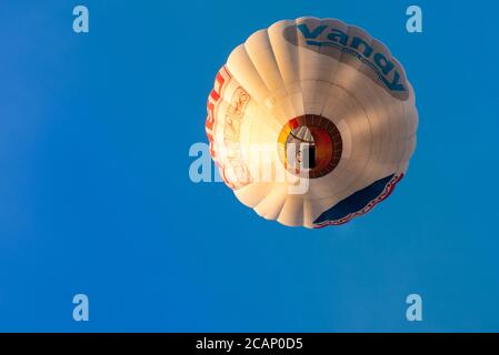 Vilnius/Lithuania - 2020-08-02: Hot air balloons from below raging through a clear light blue sky with many people inside Stock Photo