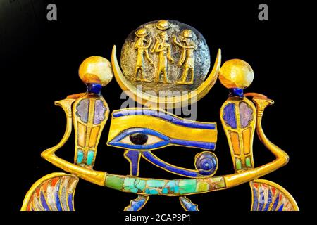 Egypt, from Tutankhamon tomb in Luxor, a part of a complex pectoral : On  a barque, an Udjat eye holds a lunar disk. Stock Photo