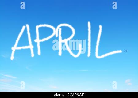 april written in the sky with contrails Stock Photo