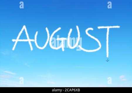 august written in the sky with contrails Stock Photo
