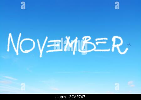 november written in the sky with contrails Stock Photo
