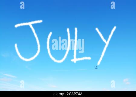 july written in the sky with contrails Stock Photo