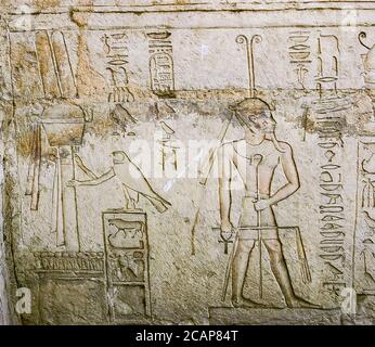 Egypt, Nile Delta, Tanis, tomb of Chechonq III, Western wall, lower register : The royal hawk holds the osirian emblem and gives bandelettes to Sokar. Stock Photo