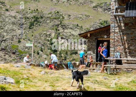 Coma Pedrosa, Andorra : 02 August 2020 : Group of Tourist in Coma Pedrosa refuge at 2266 meters of altitude in Andorra Pyrenees in summer 2020. Stock Photo