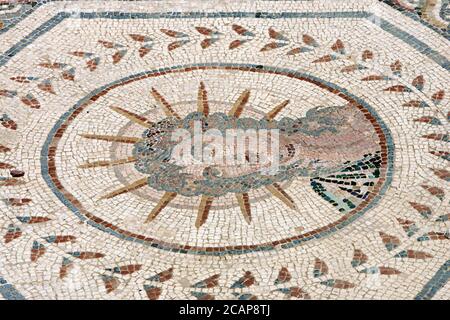 Spain, Andalusia, Seville province, Santiponce. Roman city of Italica. Founded in 206 BC by the Roman general Scipio. House of the Planetarium. Mosaic which represents the seven stars of the solar system known at that time by the Romans. Each planet is personified by a god, in turn, symbolises a day of the week. Detail of Helios or Sol, the Sun 'Sol Invictus' (Sunday). The Sun is depicted wearing a crown of rays. Stock Photo