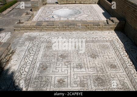 Spain, Andalusia, Seville province, Santiponce. Italica. Roman city founded in 206 BC by the Roman general Publis Cornelius Scipio. House of the Birds. Roman domus. Paved cubiculums with mosaics. Stock Photo
