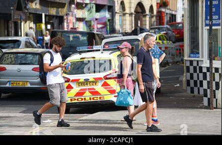 Brighton UK 8th August 2020 - Police are about on another busy day in Brighton as the temperature is forecast to reach over 30 degrees in some parts of the South East : Credit Simon Dack / Alamy Live News Stock Photo