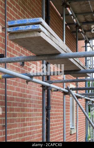 New build house with brick wall and scaffolding construction with walking boards Stock Photo