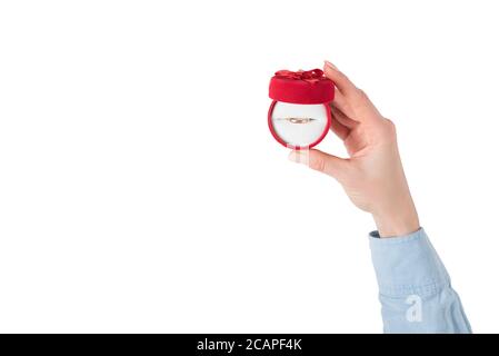 Open red jewelry box with ring in female hand. Present. Isolate Stock Photo