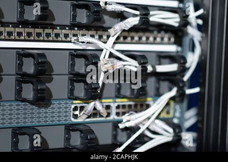 Hosting platform for modern Internet resources. Rack with server data storage equipment. Many network cables are connected to the data center equipmen Stock Photo