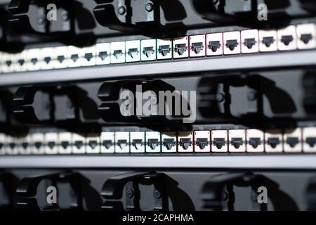 Hosting platform for modern Internet resources. Rack with server data storage equipment. Many network cables are connected to the data center equipmen Stock Photo