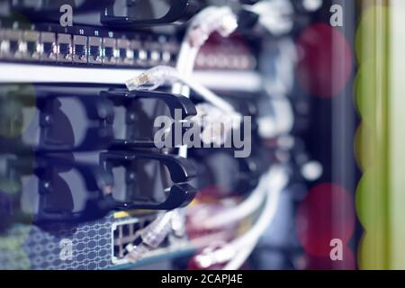 Hosting platform for modern Internet resources. Rack with server data storage equipment. Many network cables are connected to the data center equipmen Stock Photo