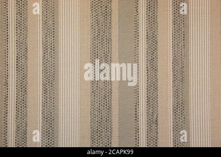 Abstract pastel background with the image of a woven fabric with classic vertical stripes of gray, white and beige. Stock Photo