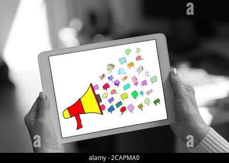 Communication concept shown on a tablet held by a woman Stock Photo