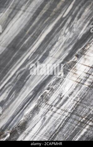 Extraction of blue marble. Marble quarry closeup.Mining industry. White marble texture in opencast mine. The surface of the marble rock Stock Photo