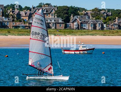 North Berwick, East Lothian, Scotland, 8th August 2020. UK Weather: Perfect day for water sports. A warm sunny day in the Firth of Forth attracts people to take to the water. East Lothian Yacht Club holds a club race as a man sails a Musto skiff sailing dinghy from West Bay Stock Photo