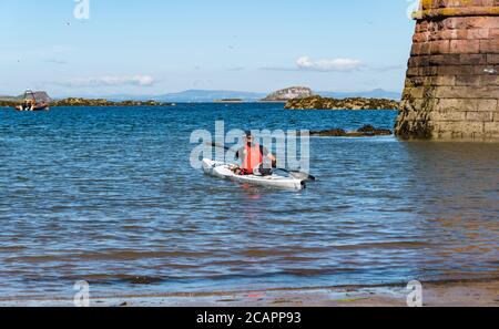 North Berwick, East Lothian, Scotland, 8th August 2020. UK Weather: Perfect day for water sports. A warm sunny day in the Firth of Forth attracts people to take to the water. A sea kayaker heads out in a kayak in West Bay Stock Photo