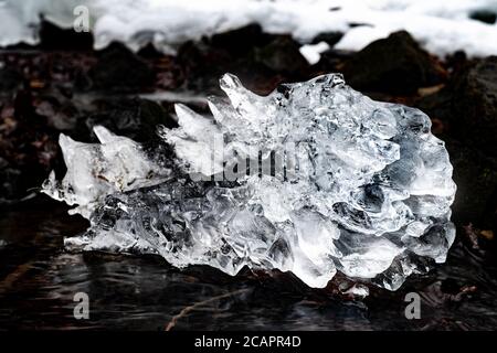 Ice piece. Cracked water ice on frozen bog. Closeup natural winter theme. Stock Photo