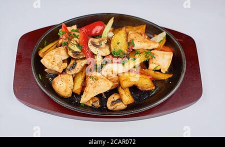 hot frying pan on a stand on a white background Stock Photo