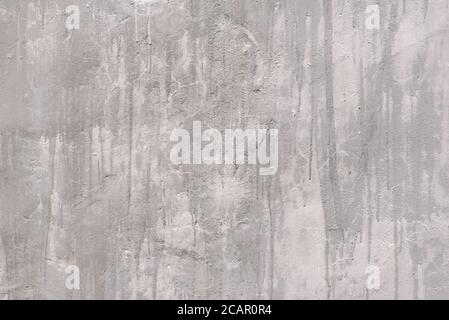 Gray rough plastered wall with smudges. Backgrounds and textures. Stock Photo