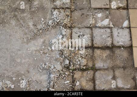 Chipping off old tiles on the terrace during renovation, replacing them with new ones. Terrace. Stock Photo