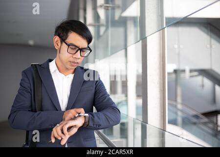 Asian businessman watching time and going to work in the morning. Stock Photo