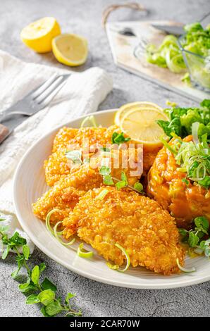 Delicious breaded meat with cornflakes and sweet potatoes Stock Photo