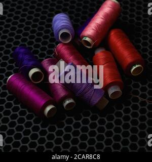 close-up multicolored threads on a dark background from above  Stock Photo