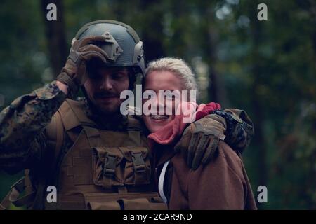 happy woman in love hugging hero soldier Stock Photo