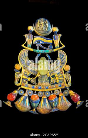 Egypt, from Tutankhamon tomb in Luxor, a complex pectoral : A winged scarab holds a barque where an Udjat eye  holds a lunar disk. Stock Photo