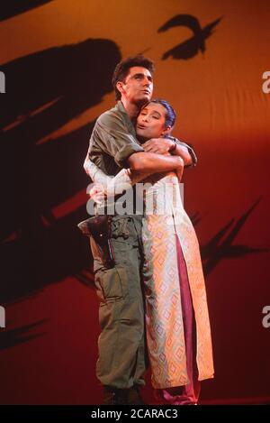 The characters Chris Scott and Kim embrace during a photo call performance of Miss Saigon stage production, Theatre Royal, Drury Lane, London, UK. Circa 1989 Stock Photo