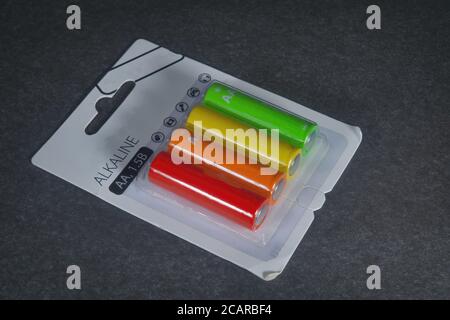 Packing electric alkaline batteries on a dark background. Stock Photo