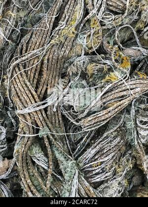 Old rusty dirty thin ropes, textured closeup. Rope decay decompose Stock Photo