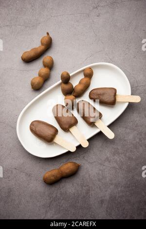 Imli stick Candy or Tamarind Lollipop is kids favourite sweet food in India Stock Photo