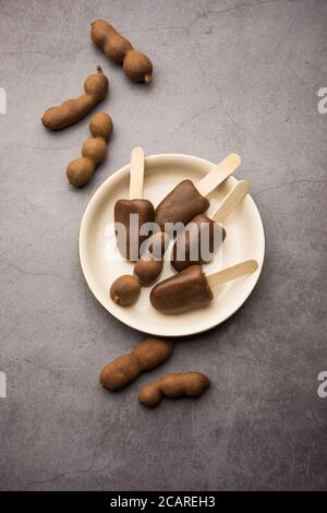 Imli stick Candy or Tamarind Lollipop is kids favourite sweet food in India Stock Photo