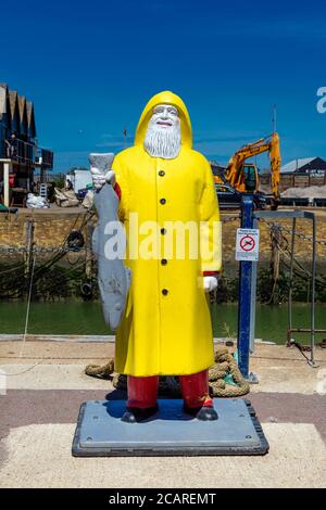 Fisherman statue outside the fish market in Whitstable Harbour, Kent, UK Stock Photo