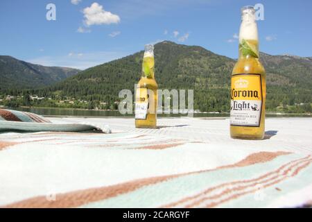 Two bottles of Corona Light on a dock by the lake on a summer day. Stock Photo