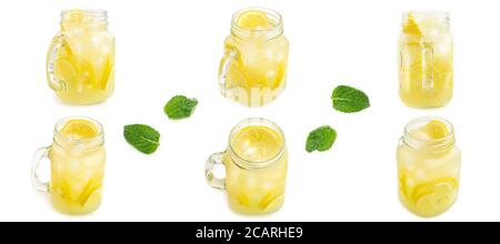 Mason jar with ice lemonade and leaves of mint from different sides on white background. Macro photo. Stock Photo