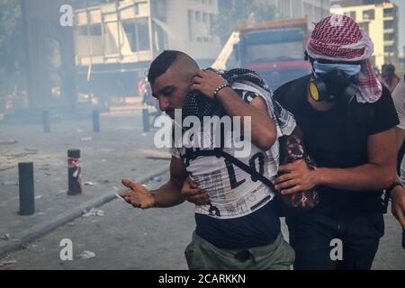 Beirut, Lebanon. 08th Aug, 2020. An anti-government demonstrator is evacuated after being wounded during clashes with riot police during a protest in the aftermath of Tuesday's explosion. Credit: Marwan Naamani/dpa/Alamy Live News Stock Photo