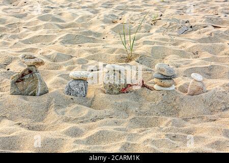 a group of found rocks stacked on a Montauk beach in Montauk, NY Stock Photo
