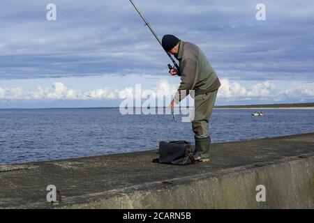 a man caught a fish on a fishing rod, fishing on a Salak, fishing