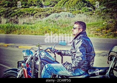 side view of a biker on a classic motorcycle in hdr Stock Photo