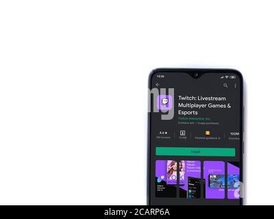 Lod, Israel - July 8, 2020: Twitch app play store page on the display of a black mobile smartphone isolated on white background. Top view flat lay wit Stock Photo